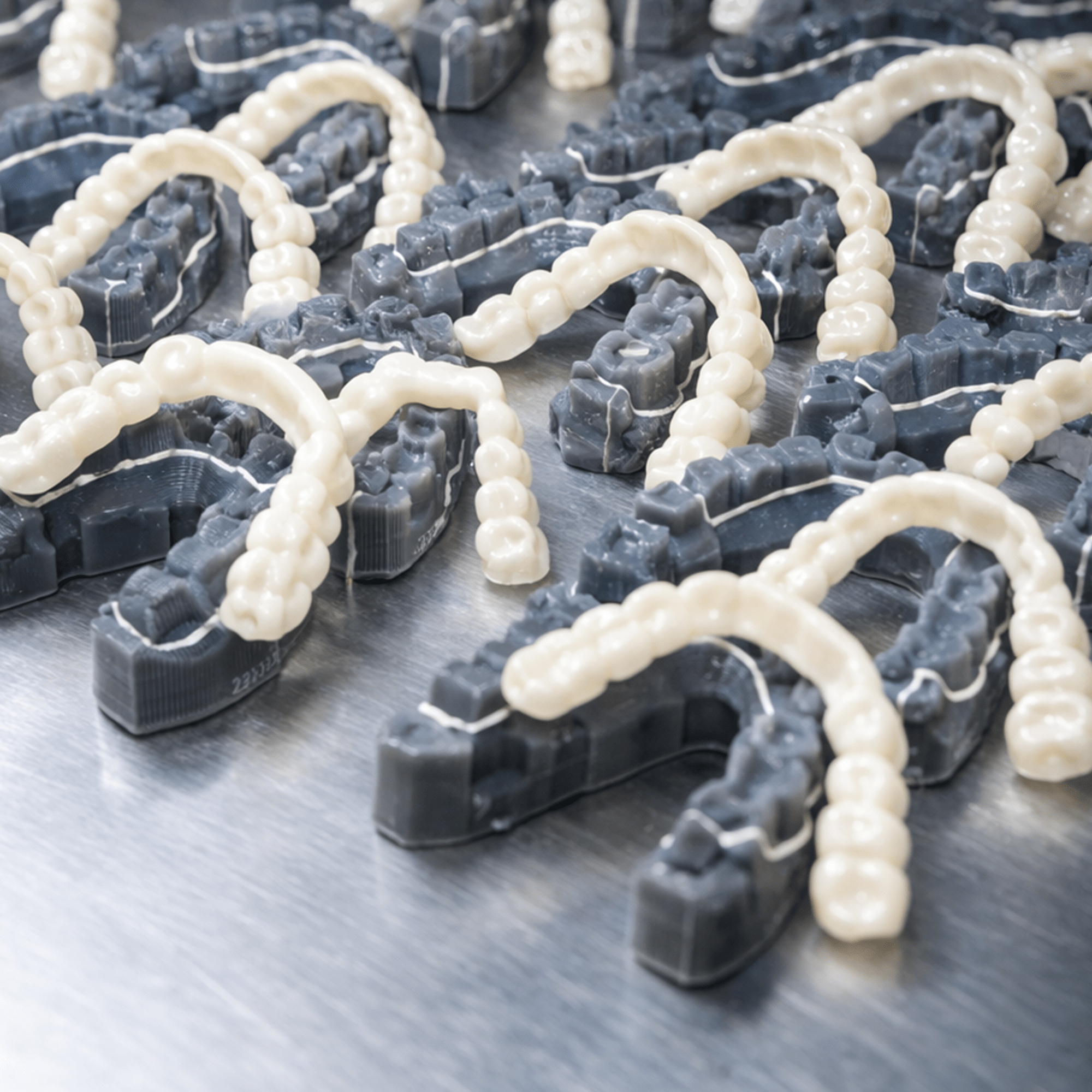 Close-up of with clip on veneers on a metallic surface